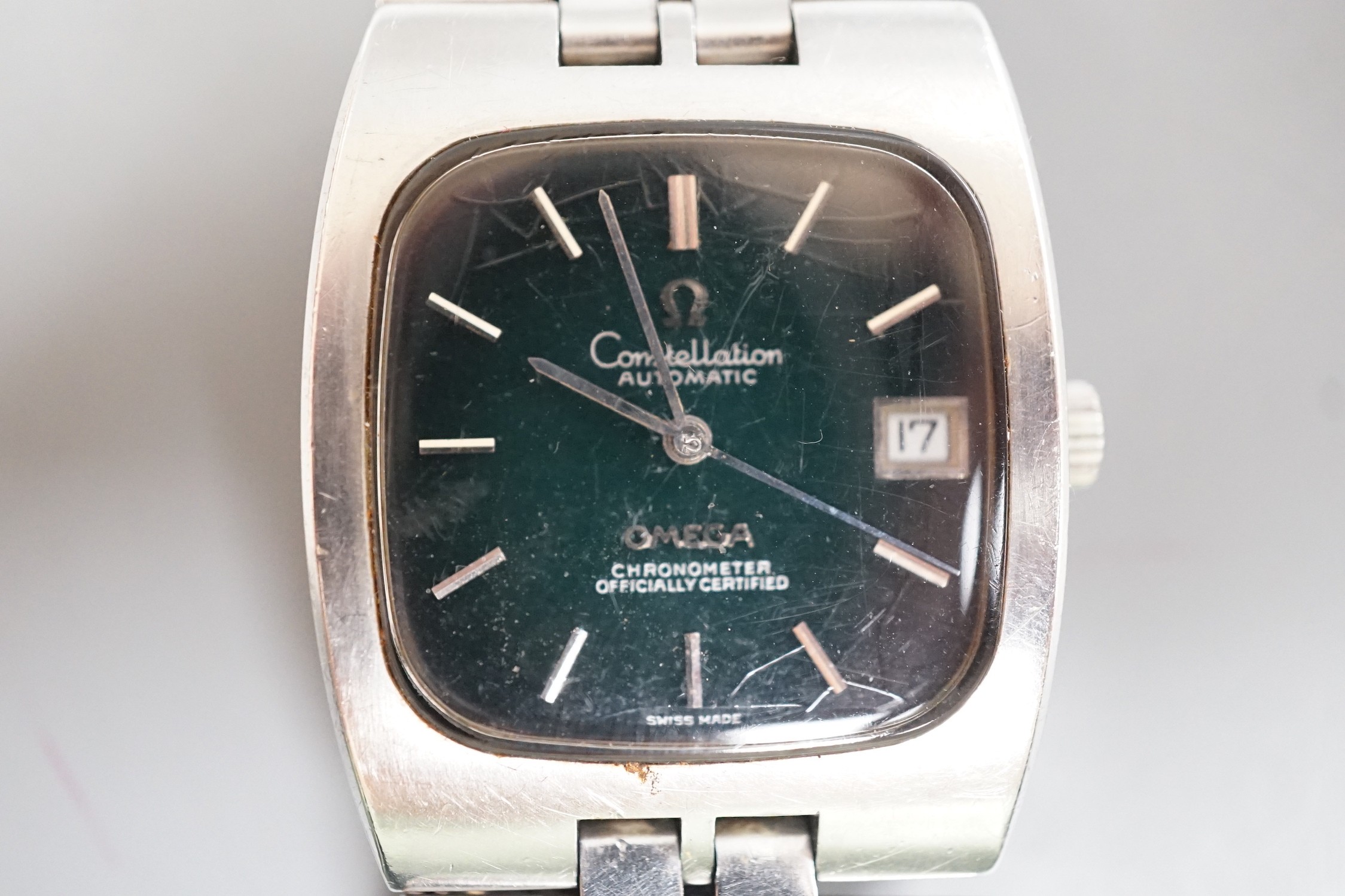 A gentleman's early 1970's stainless steel Omega Constellation chronometer black dial wrist watch, with bate numerals and date aperture, on stainless steel Omega bracelet, case diameter 33mm, with Omega box.